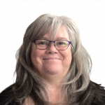 Headshot of Debra Levitt wearing glasses, smiling
